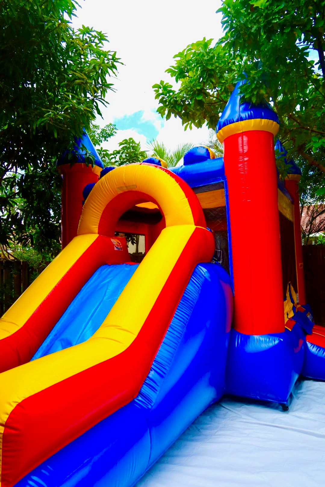 Bright red yellow and blue slide bounce house rental in Miami